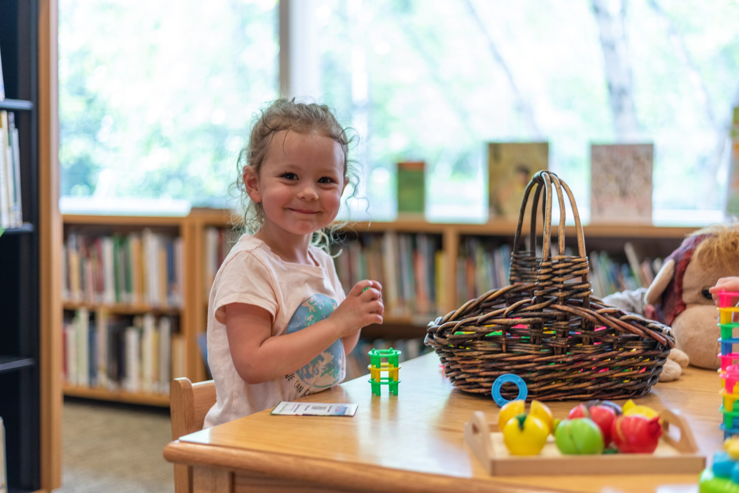 Cute little preschooler playing with colorful building toys